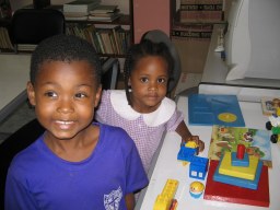 children playing at a desk with toys